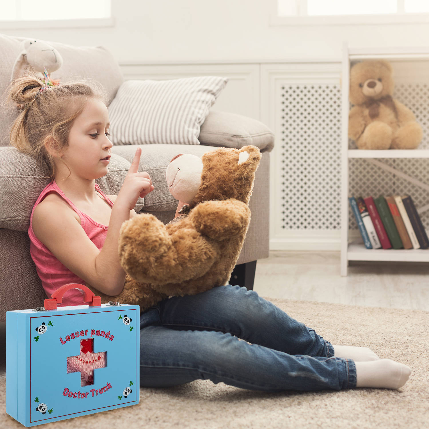 Little girl hugging her teddy bear on floor