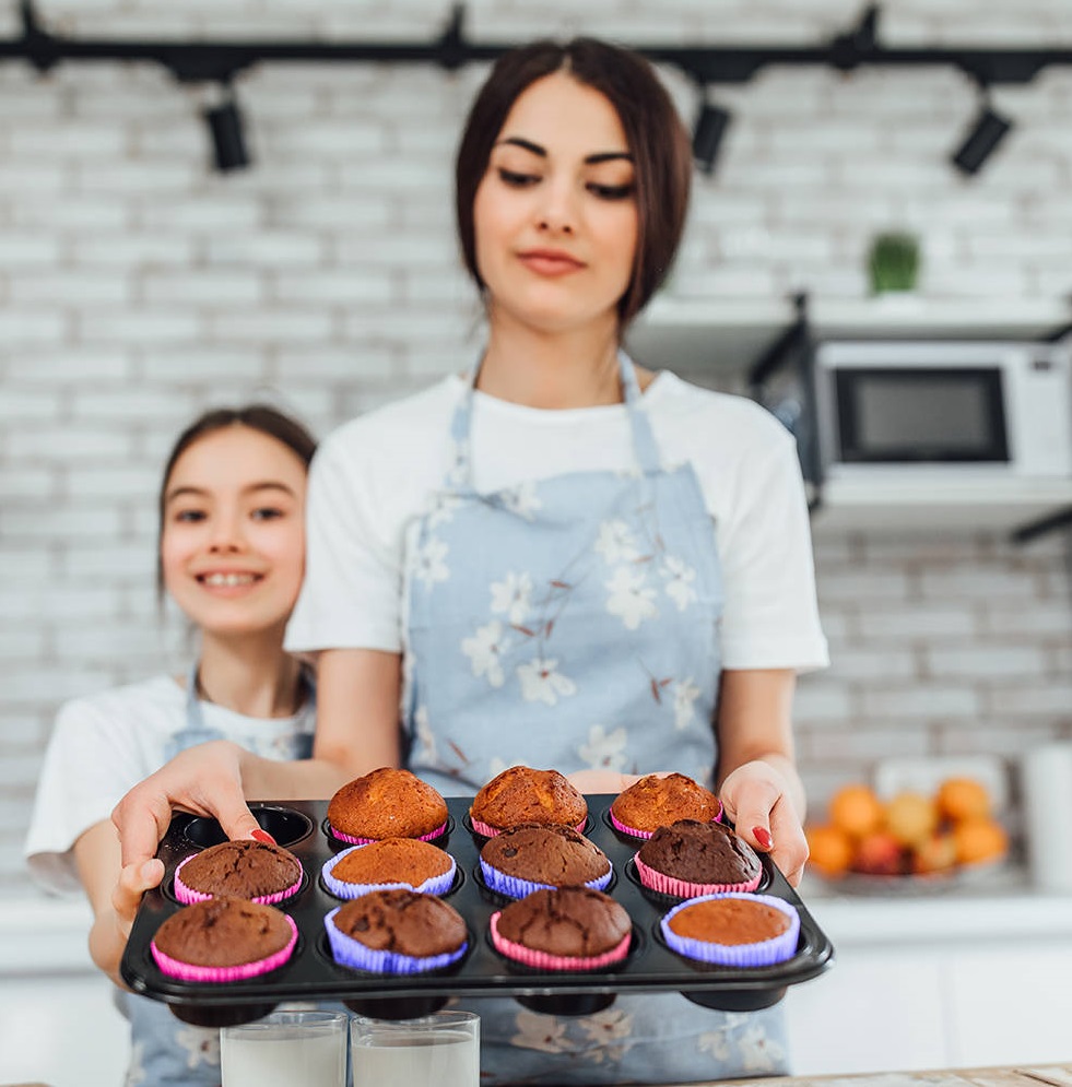 Young beautiful sisters cooking cupcakes, portrait home sweet homemade!