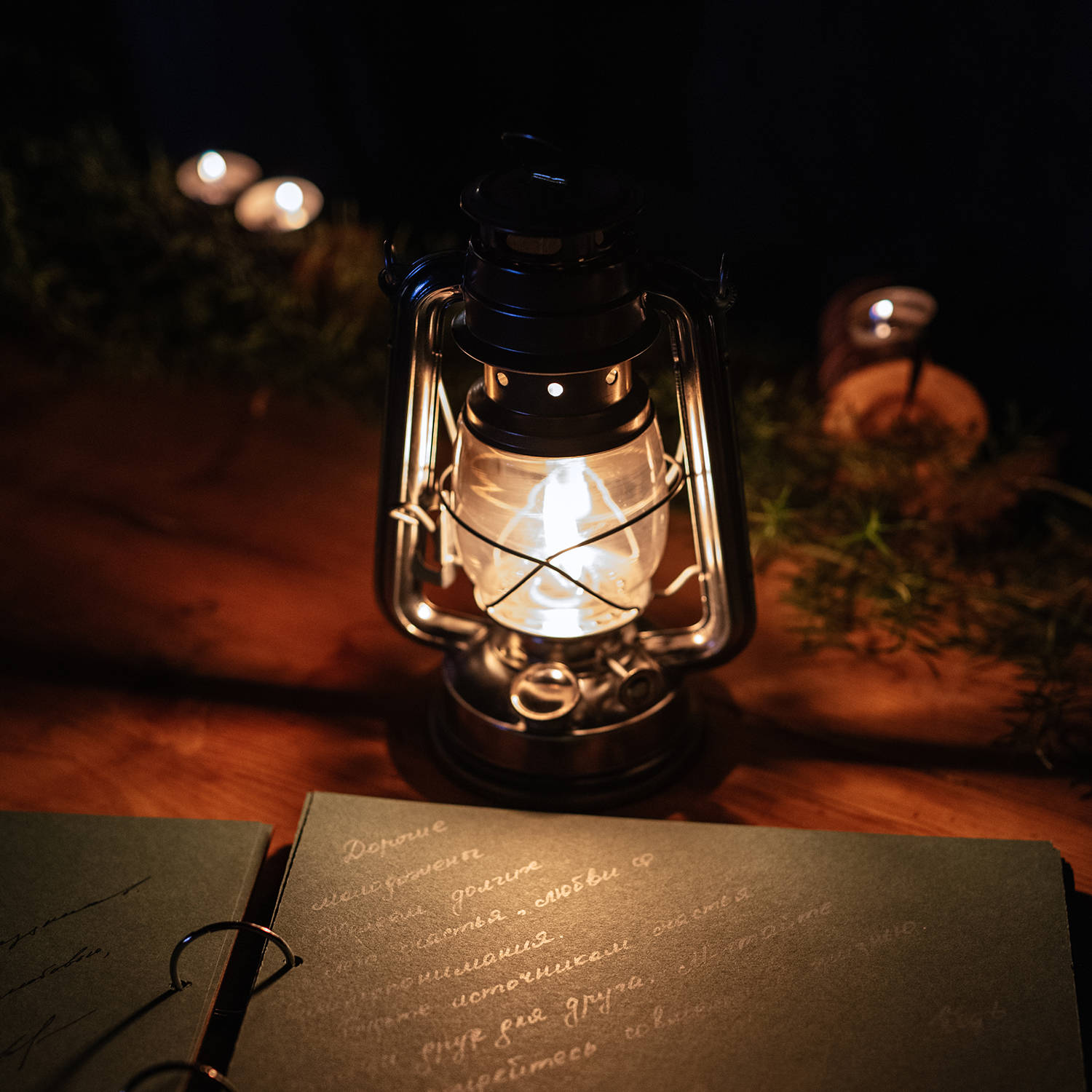 burning candles on a dark night in a wooden lantern